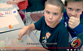 boys giving thumbs up at table with bouncy ball 
