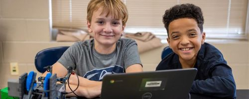  Two boys building robots.