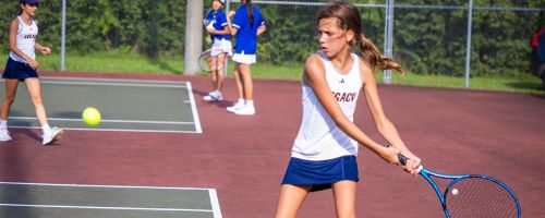  Female tennis player about to hit a tennis ball.