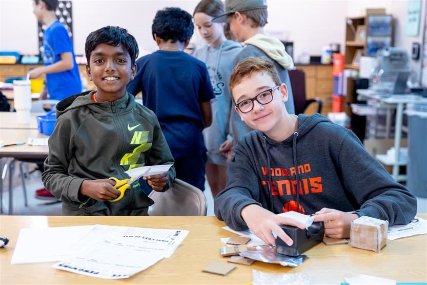  two students shown with "nests" built for penguin ice cubes