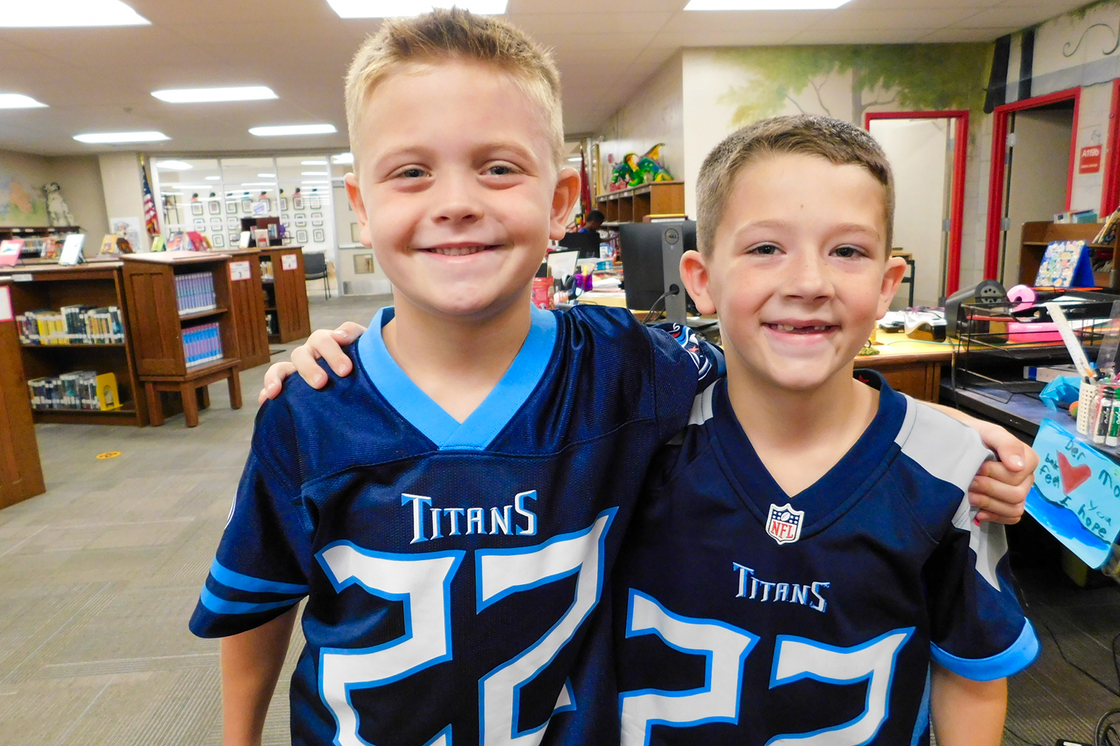 two boys in Titans jerseys smiling