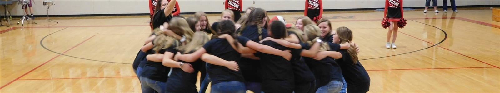 Students huddle up to cheer