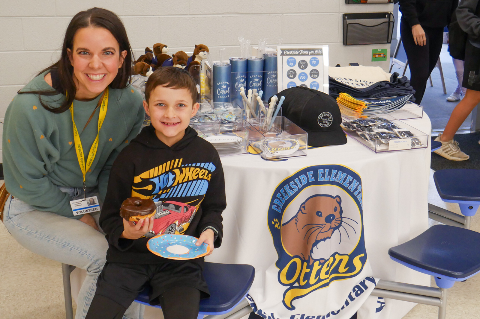 mom and son with table of creekside gear