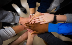  Image shows many hands joining in 