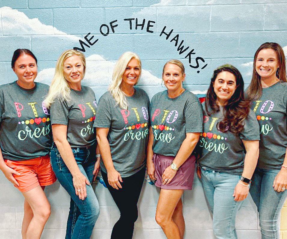 PTO volunteers against a blue backdrop