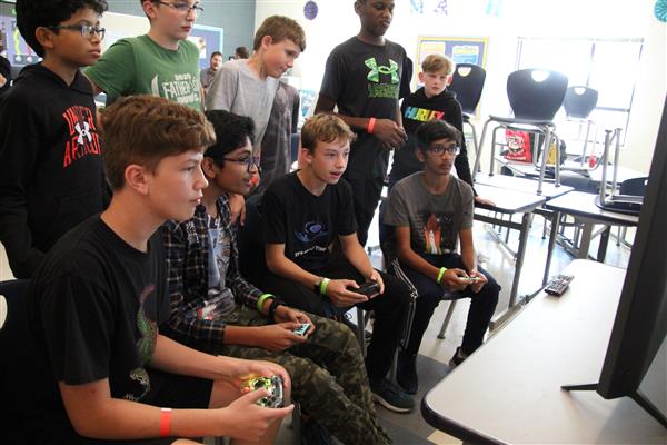 A group of students play video games.