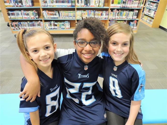 Three students wearing Titans uniforms.