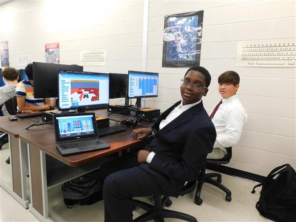 VEX VR students are shown working on their computers