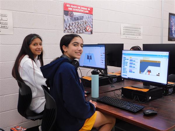 VEX VR students are shown working on their computers
